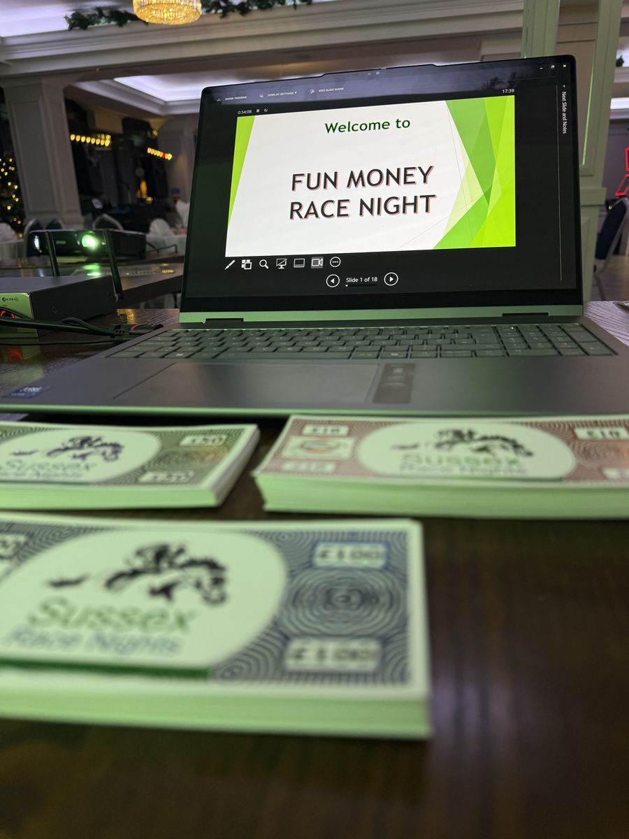 Stacks of branded Sussex Race Nights fun money beside the welcome screen