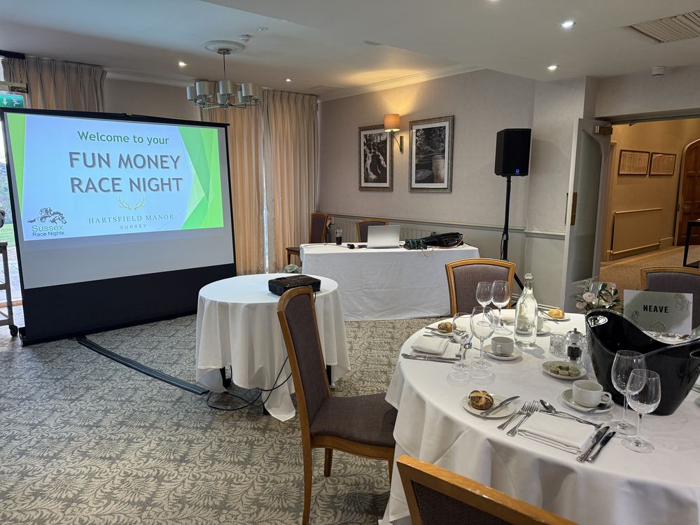 A co-branded Fun Money Race Night welcome screen in a hotel function room